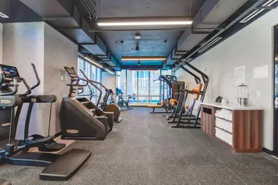 a gym with treadmills and elliptical machines at Luxury One-Bedroom w Top Amenities! in Miami
