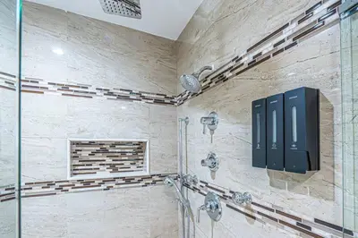 a bathroom with a shower with two faucets at Miami amazing location, Luxury & Spacious, Large pool, BBQ, Game room, Pool in Miami