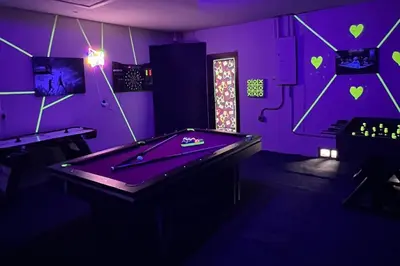 a purple room with a pool table in it at Miami amazing location, Luxury & Spacious, Large pool, BBQ, Game room, Pool in Miami