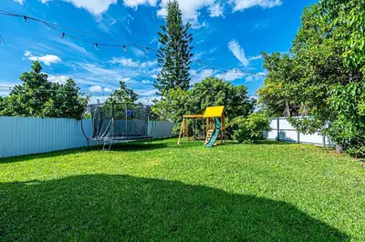 a yard with a swing set and a playground at Miami amazing location, Luxury & Spacious, Large pool, BBQ, Game room, Pool in Miami