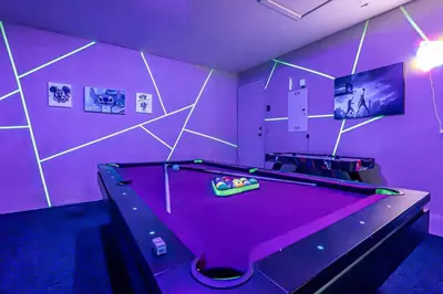 a purple room with a pool table in it at Miami amazing location, Luxury & Spacious, Large pool, BBQ, Game room, Pool in Miami