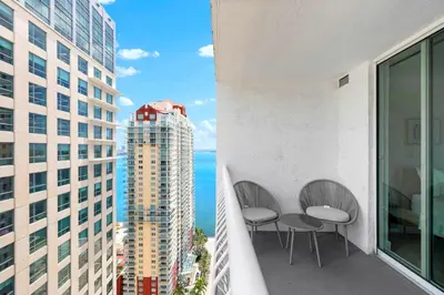 a balcony with two chairs and a view of the ocean at Beautiful Condo w Breathtaking Views! in Miami