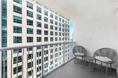 two chairs on a balcony with a building at Beautiful Condo w Breathtaking Views! in Miami