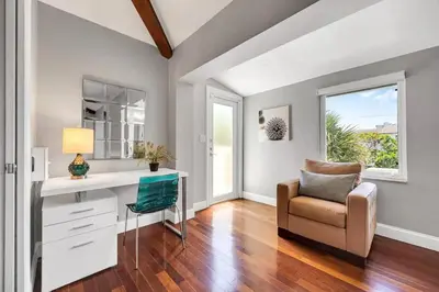 a home office with a desk and a chair at Steps to Beach, Pool, Backyard Oasis, Game Room in Fort Lauderdale