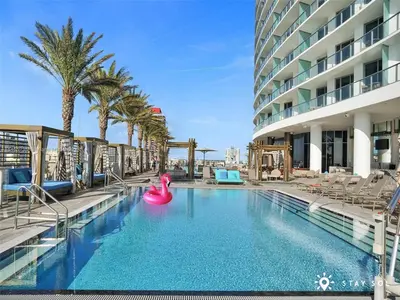 a swimming pool with a pink raft in a hotel at Seaside Elegance 1BR Retreat Stunning View in Hollywood