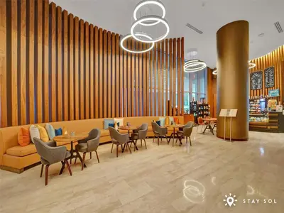 a lobby with a couch and tables and chairs at Seaside Elegance 1BR Retreat Stunning View in Hollywood