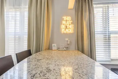 a dining room table with a sign on the wall at Luxe ocean drive condo in miami south beach in Miami Beach