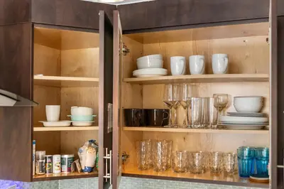 a cabinet filled with glasses and plates and dishes at Luxe ocean drive condo in miami south beach in Miami Beach