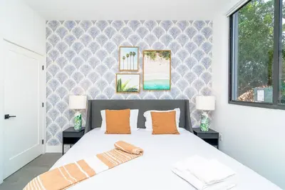a bedroom with a white bed with two lamps at Cozy Miami 2BR Oasis Near Brickell, Calle Ocho & Marlins Stadium in Miami