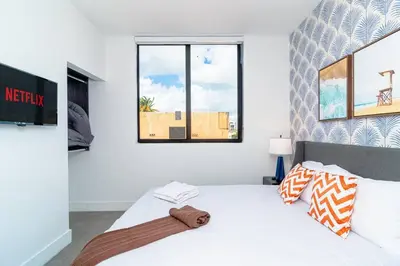 a bedroom with a large white bed and a window at Cozy Miami 2BR Oasis Near Brickell, Calle Ocho & Marlins Stadium in Miami