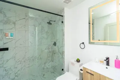 a bathroom with a shower and a toilet and a sink at Central Miami 1BR Suite Close to Beach & Downtown in Miami
