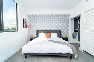 a bedroom with a large bed and a large window at Bright 1BR with Netflix and King Bed Near Brickell and Marlins Park in Miami