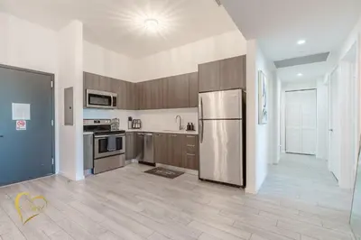 a kitchen with a stainless steel refrigerator in a room at Lumiére Penthouse in Miami