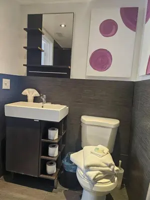 a bathroom with a sink and a toilet and a mirror at Great 1BedRoom RENOVATED 1 minute from the BEACH in Miami Beach