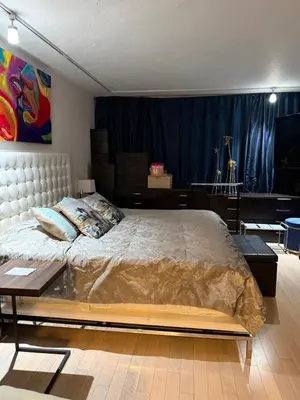a bedroom with a large bed and a table at Penthouse 2 stroy 2 bedroom water views to share in Miami