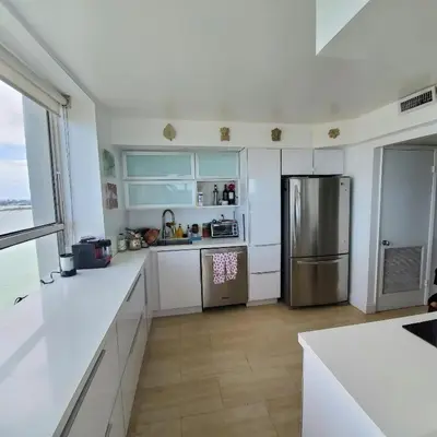 a kitchen with white counters and a stainless steel refrigerator at Penthouse 2 stroy 2 bedroom water views to share in Miami