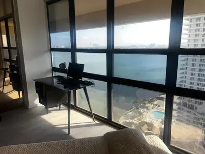 a room with a laptop computer on a desk in front of a window at Penthouse 2 stroy 2 bedroom water views to share in Miami