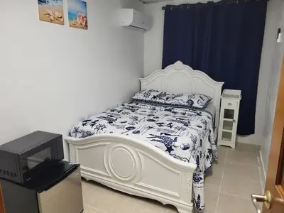 a bedroom with a white bed and a tv at Azucar Miami in Miami