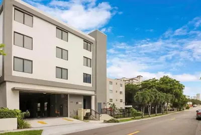 a white building on the side of a street at Chic Spacious Studio Miami Stay Near Marlins Park & Brickell in Miami