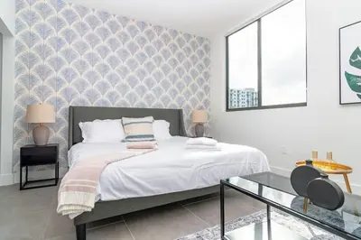 a bedroom with a bed and a glass table at Chic Spacious Studio Miami Stay Near Marlins Park & Brickell in Miami