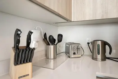 a kitchen counter with utensils and a toaster at Luxury & Modern Condo in Design District with Pool in Miami
