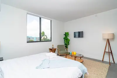 a white bedroom with a bed and a window at Cozy and Comfortable 1BR Near Calle Ocho and Brickell in Miami