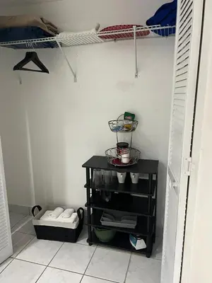 a walk in closet with a black shelf in a room at Private Studio in West Hialeah in Hialeah