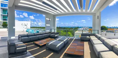 a living room with couches and chairs on a balcony at Elegant Condo 2BR w Beautiful City Views in Miami