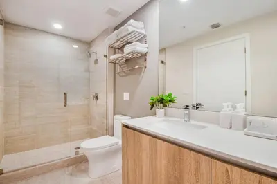 a bathroom with a white sink and a toilet at Elegant Condo 2BR w Beautiful City Views in Miami