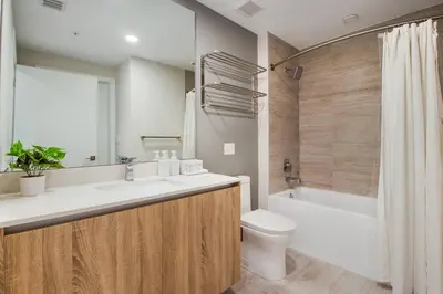 a bathroom with a sink and a toilet and a tub at Elegant Condo 2BR w Beautiful City Views in Miami