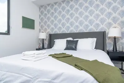 a bedroom with a white bed with towels on it at Central 1BR in Miami with King Bed Near Wynwood and Marlins Park in Miami
