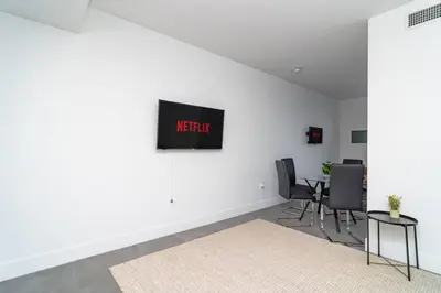 a white room with chairs and a sign on the wall at Central 1BR in Miami with King Bed Near Wynwood and Marlins Park in Miami