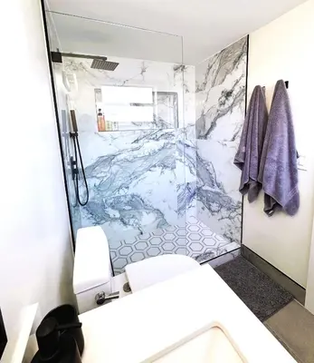 a bathroom with a marble shower and a toilet at Homey Haven in Vibrant South Beach in Miami Beach