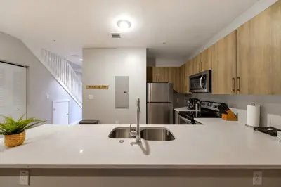 a kitchen with a sink and a counter top at Spacious 3BR Townhouse with Free Parking Included! in Miami