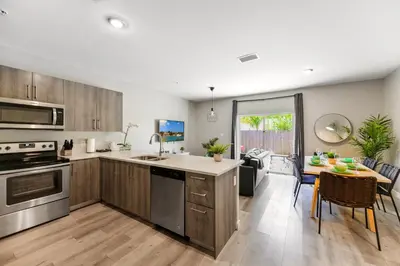 a kitchen and living room with a table and a dining room at Spacious 3BR Townhouse with Free Parking Included! in Miami