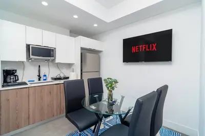 a kitchen and dining room with a glass table and chairs at Beautiful 1BR in Little Havana Close with King Bed Near Brickell & Marlins Park in Miami