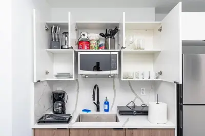 a kitchen with a sink and a microwave at Beautiful 1BR in Little Havana Close with King Bed Near Brickell & Marlins Park in Miami