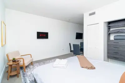a bedroom with a bed and a clock on the wall at Well Located 1BR with King Bed, Laundry and Parking Option Near Brickell and Marlins Park in Miami