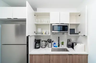 a white kitchen with a sink and a refrigerator at Miami 1BR New Oasis with King Bed Near Brickell & Marlins Park in Miami