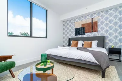 a bedroom with a king sized bed and a couch at Miami 1BR New Oasis with King Bed Near Brickell & Marlins Park in Miami
