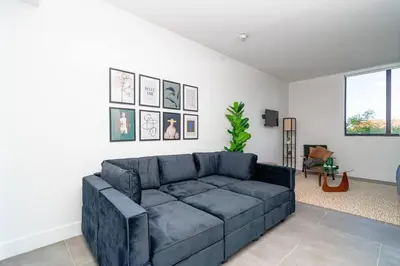 a living room with a blue couch in a room at Miami 1BR New Oasis with King Bed Near Brickell & Marlins Park in Miami