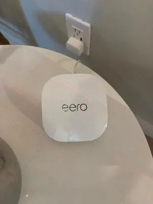 a white electronic device sitting on top of a toilet at Anselmo Brickell Apartments in Miami