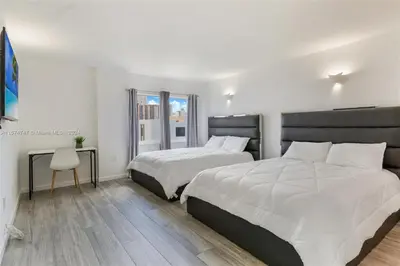 a bedroom with two beds and a window at Skyline Paradise in Sunny Isles Beach in Sunny Isles Beach