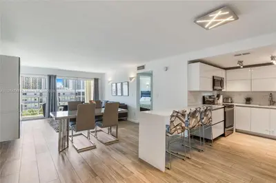 an open kitchen and dining room with a table and chairs at Skyline Paradise in Sunny Isles Beach in Sunny Isles Beach