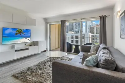 a living room with a couch and a tv at Skyline Paradise in Sunny Isles Beach in Sunny Isles Beach
