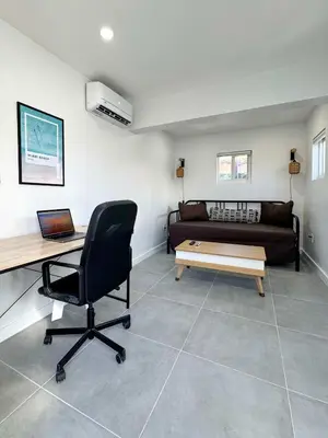a living room with a desk and a couch at Quiet Shenandoah Retreat, Central Miami in Miami