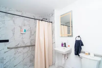 a bathroom with a shower curtain and a sink at Luxury Studio Suite with King Bed Near Brickell & Marlins Park in Miami