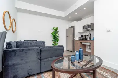 a living room with a couch and a glass table at Prime Miami Retreat with King Bed Near Brickell & Marlins Park in Miami