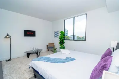 a white bedroom with a bed and a window at Stylish Studio Miami Suite Oasis Near Calle Ocho & Brickell in Miami