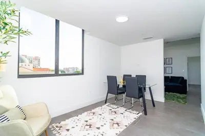 a living room with a table and chairs at Stylish 2BR Miami Retreat Mins to Wynwood and Brickell in Miami